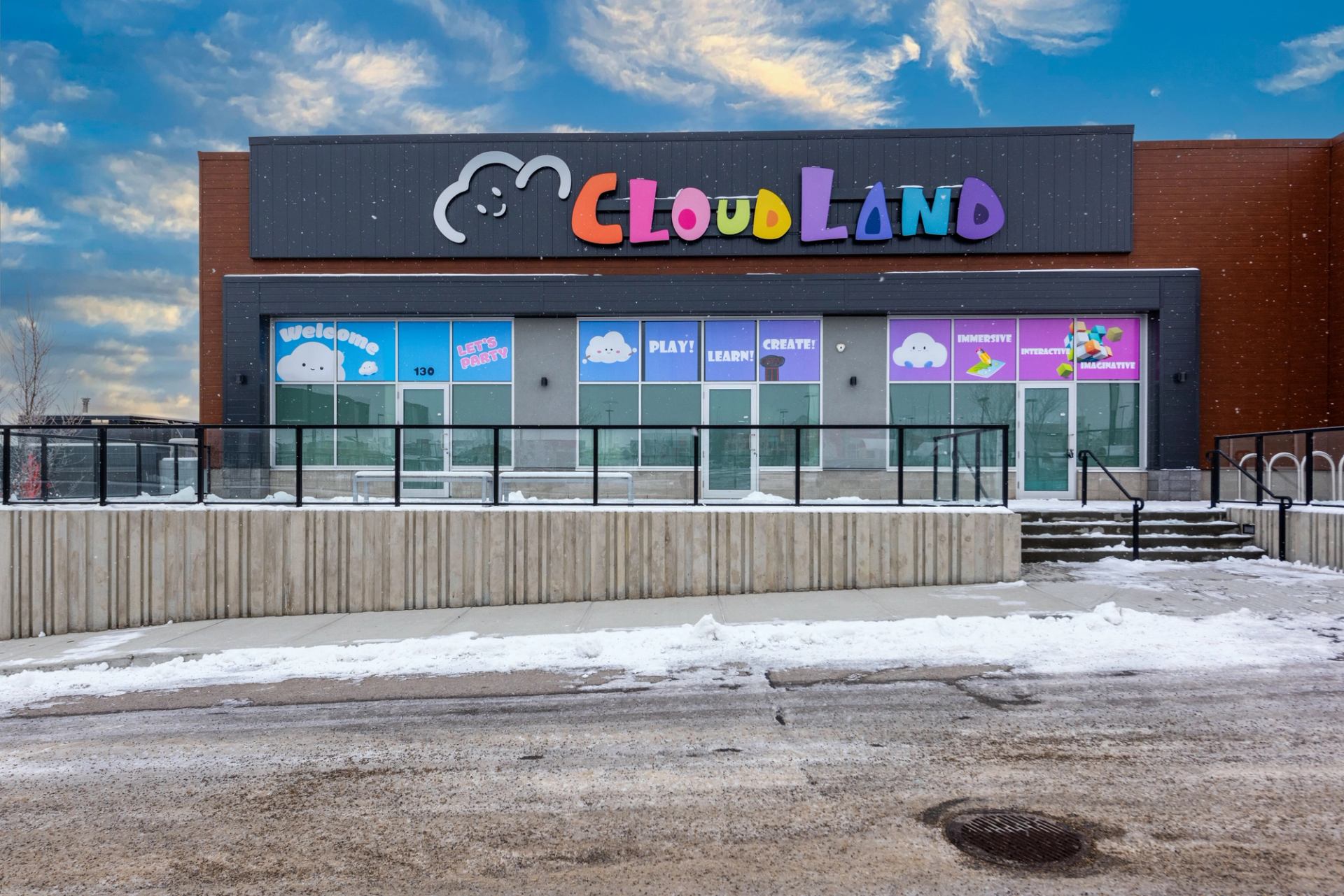 Colorful Cloud Land interactive playground building with snowy entrance.
