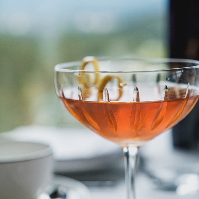 Orange cocktail with lemon twist at Fairmont Banff Springs.