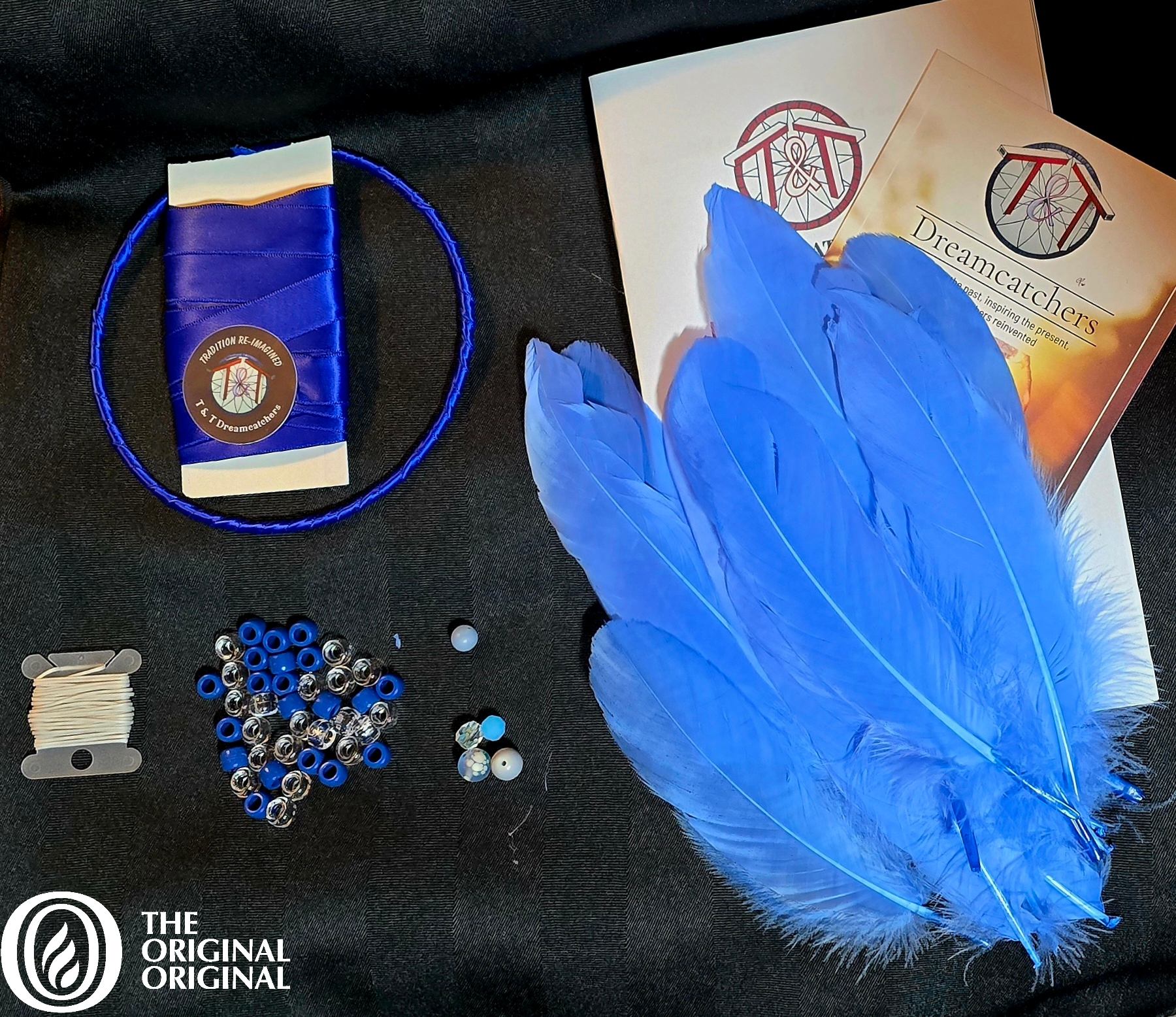 Dreamcatcher craft kit with blue feathers, beads, thread, hoop and instruction cards.