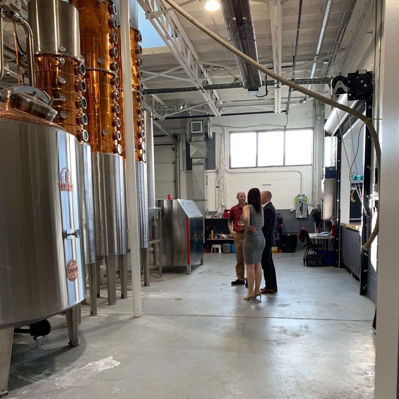 A group of people doing a distillery tour.