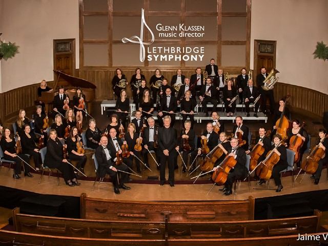 Lethbridge Symphony Orchestra posing with their instruments