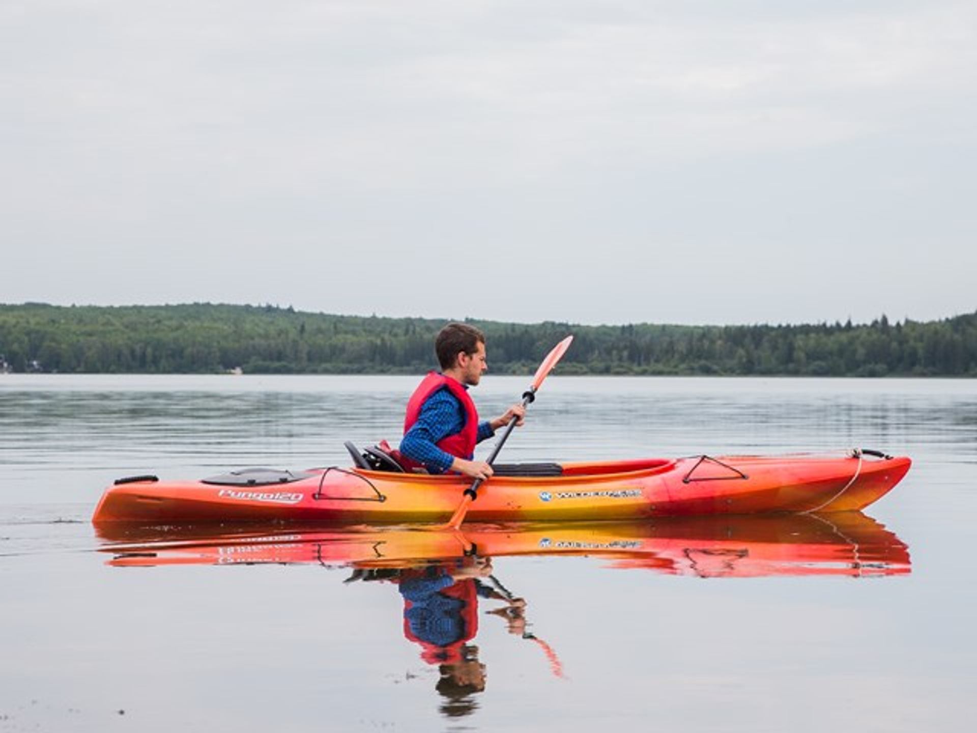 Person kayaking in the lake.