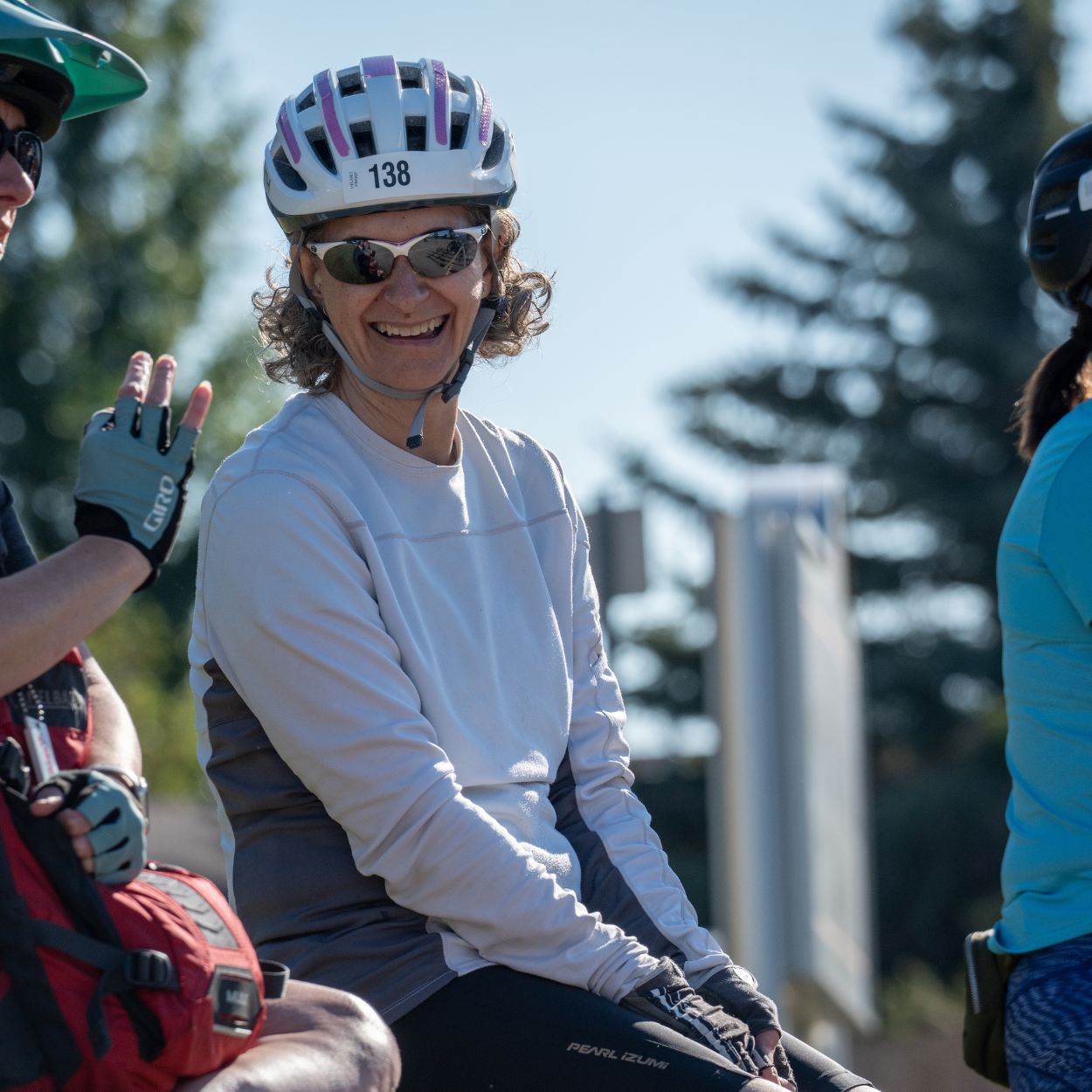 A women sat smiling with her biking gear on.