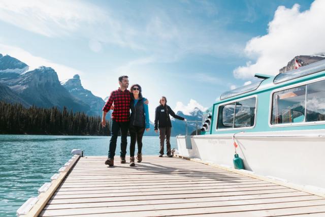 A scenic shot of couple on dock after a Maligne Lake Cruise.