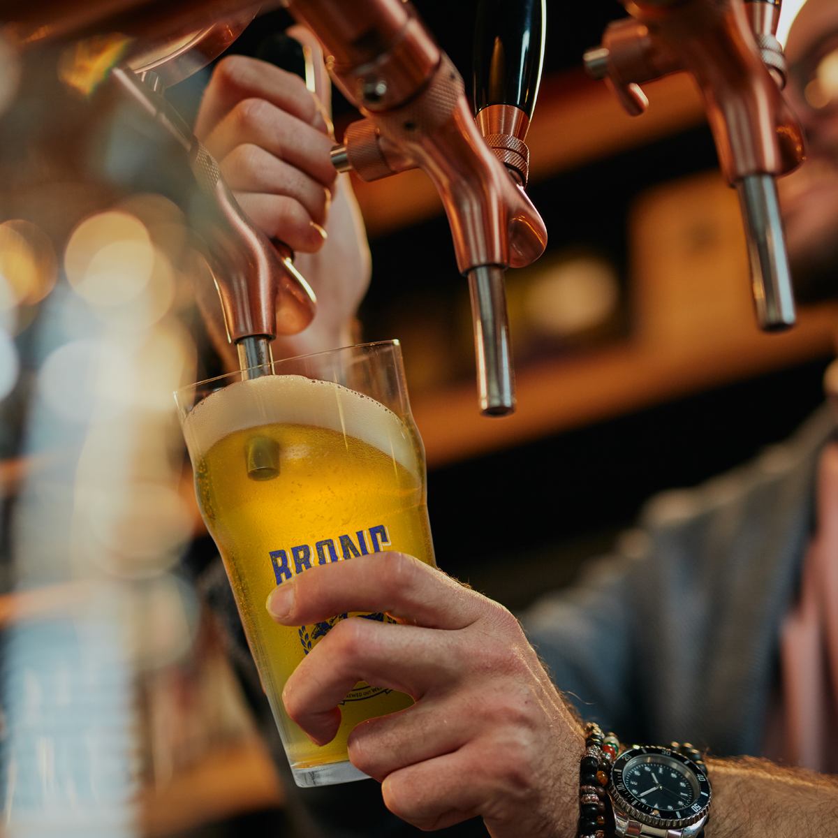 Pouring a pint of Bronc Beer.