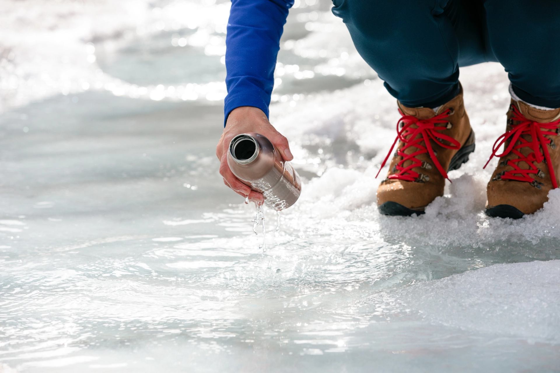 Person getting water from the Columbia Icefield Glacier.