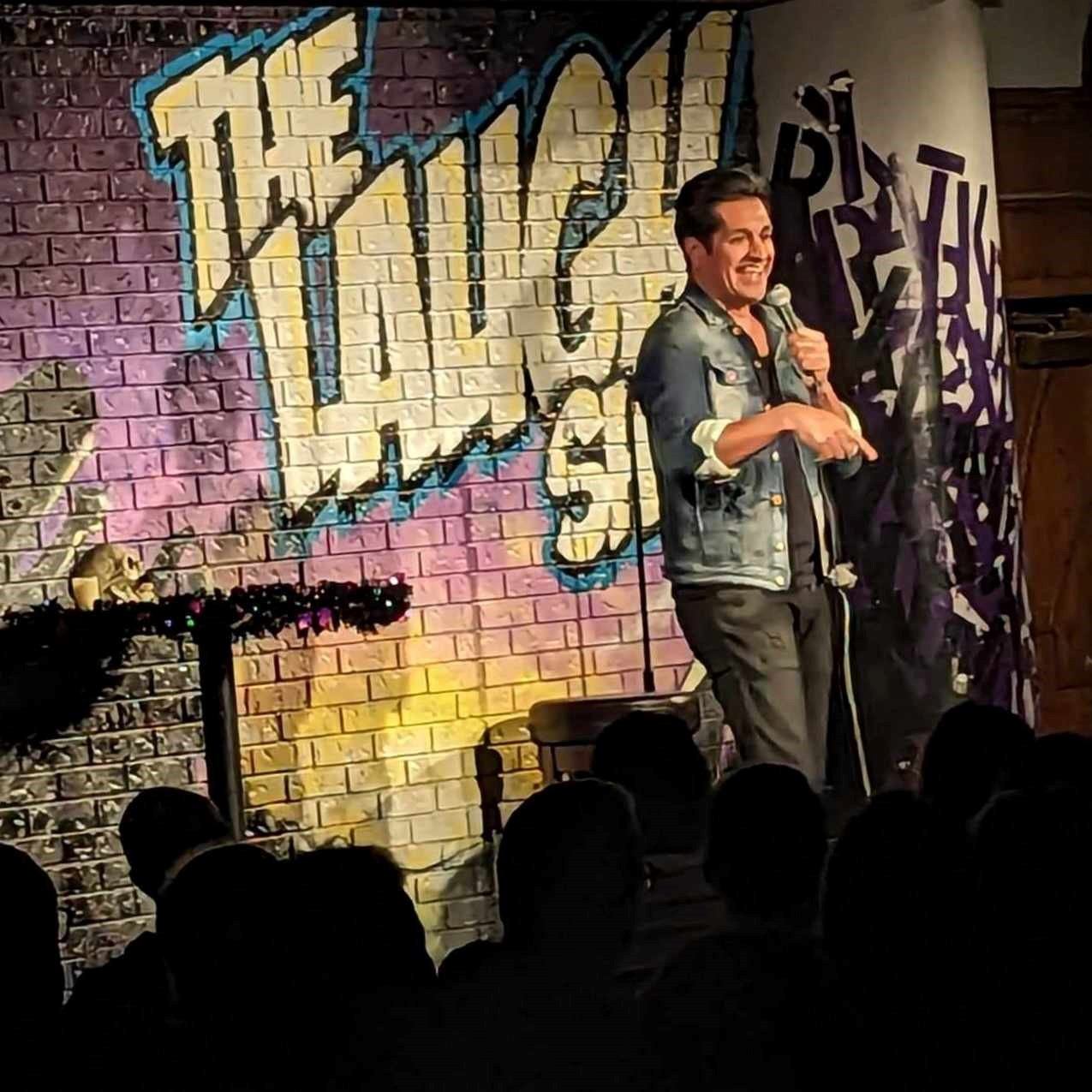 Stand-up comic on stage at The Laugh Shop.