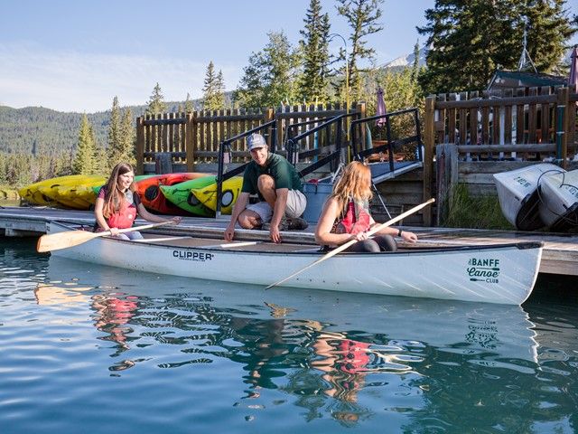 People getting into a rental canoe at the dock.