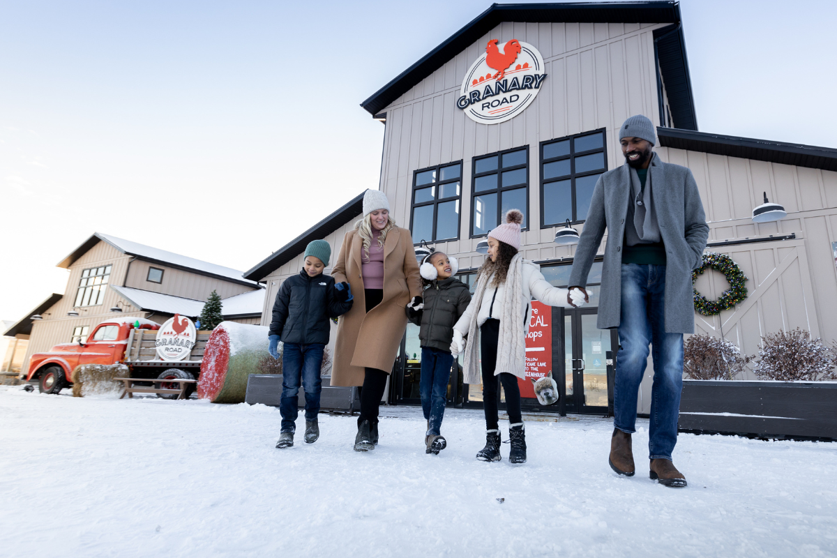 Family walks in snow by Granary Road, decked out for Christmas.