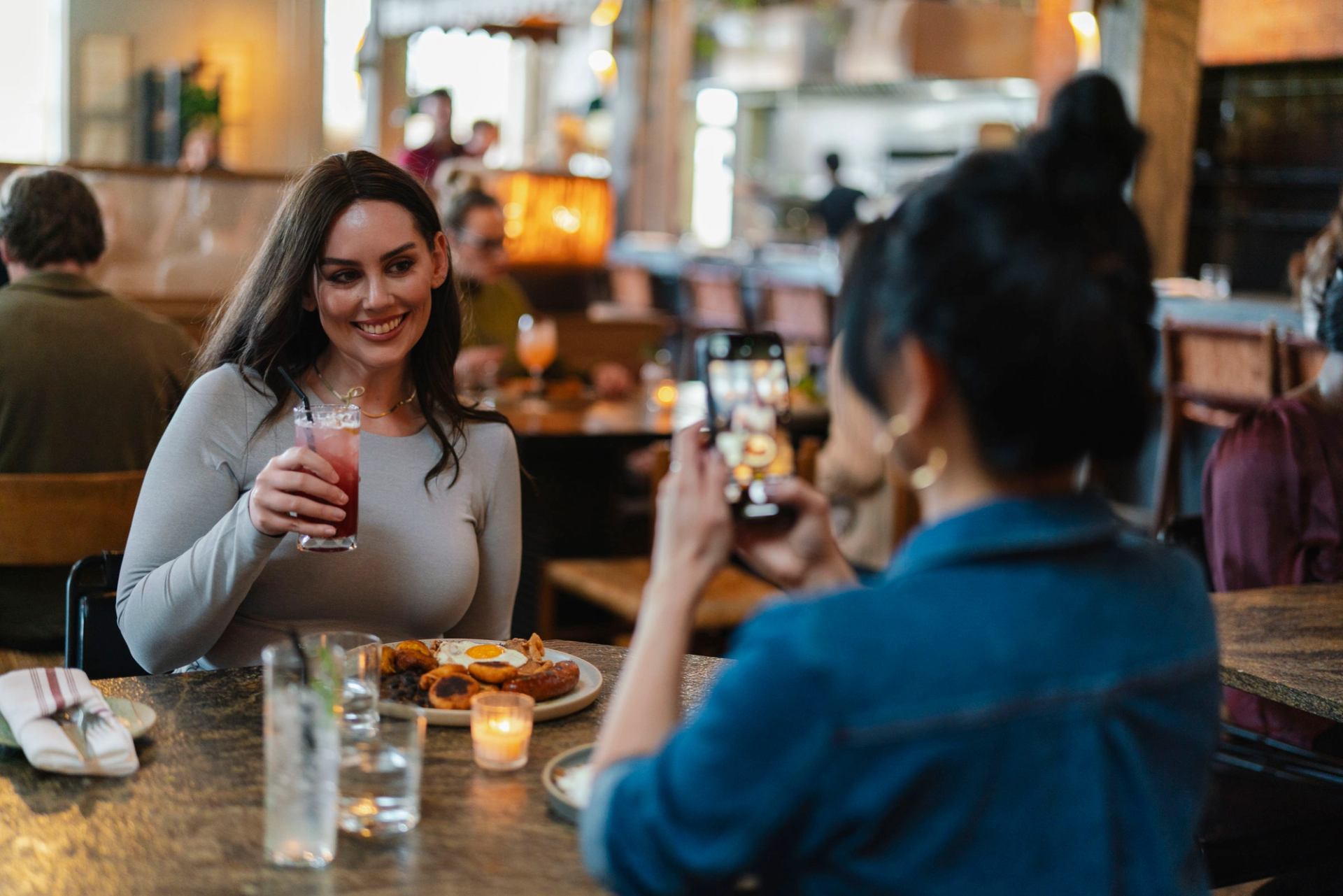 Two friends enjoying food and drinks at Fortuna's Row