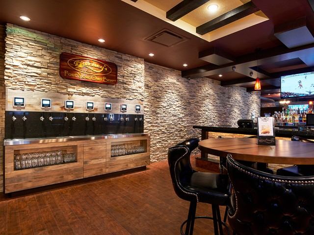 Barney's Pub interior with self-serve beer taps and cozy seating.