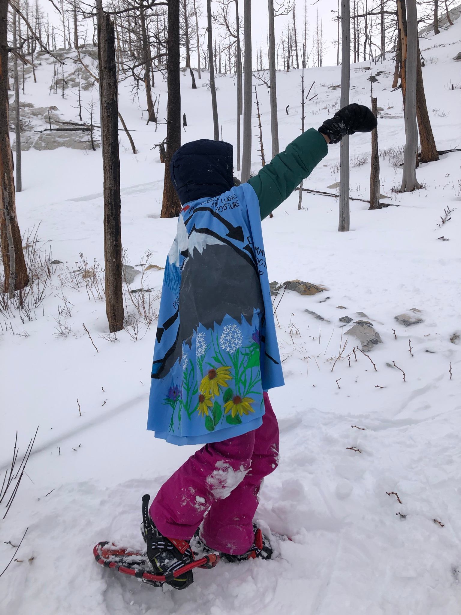 A young child feeling empowered by the stories told on the Waterton Winter Wonderland tour.