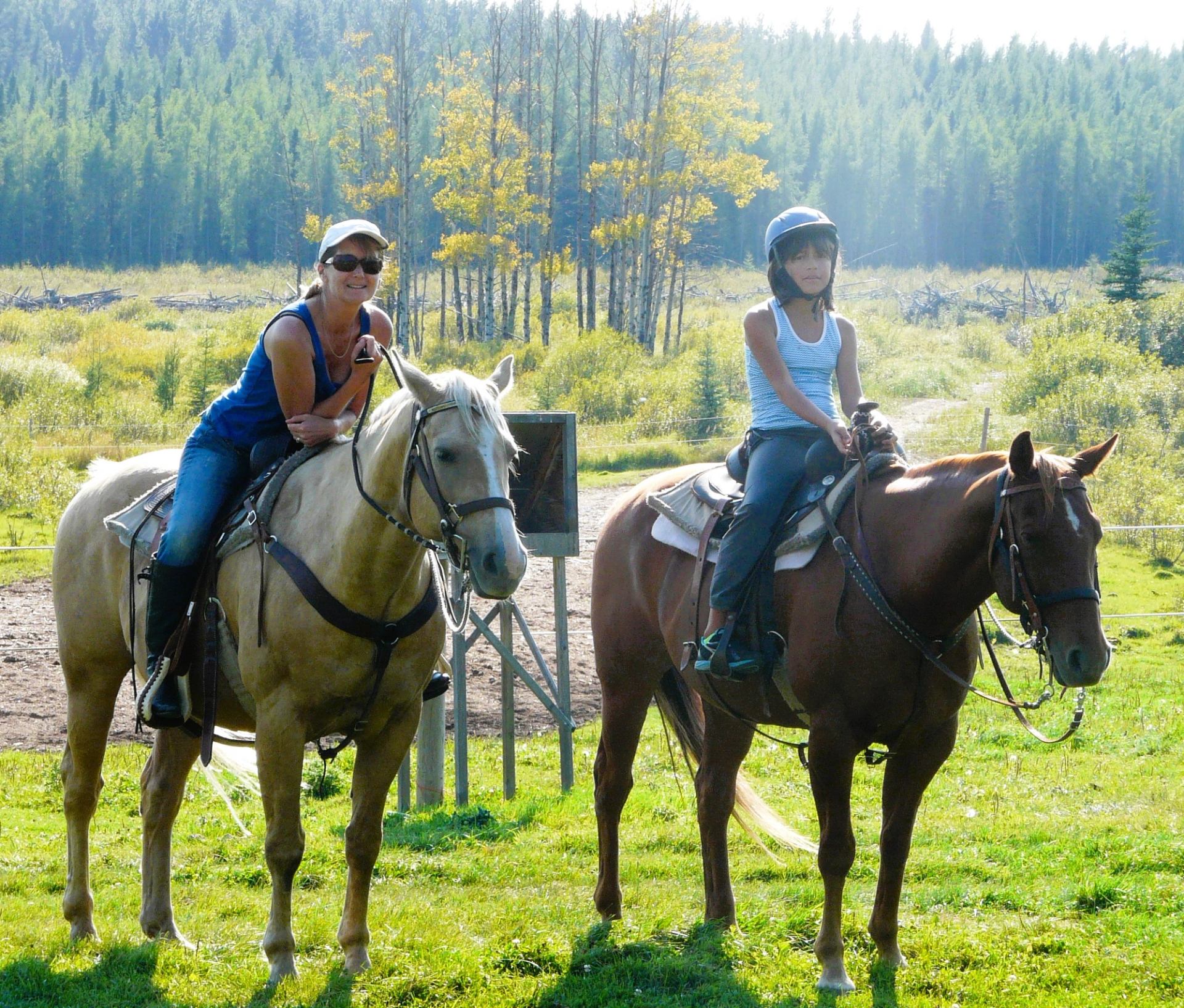 A mother and daughter riding horses together
