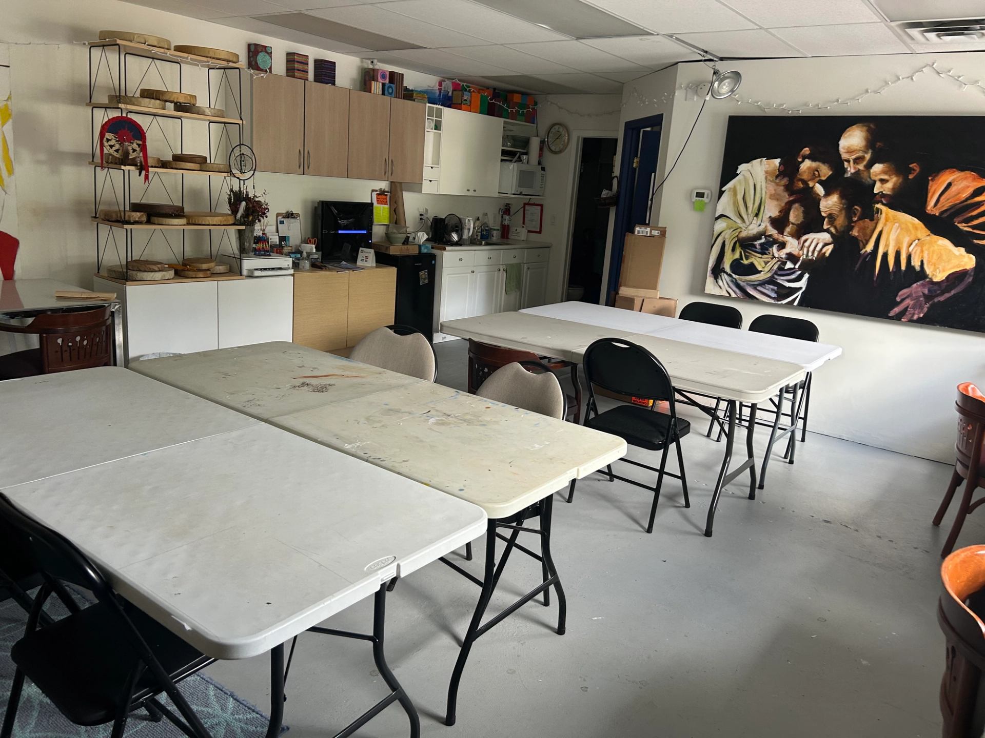 Art studio with painting tables and a mural on the wall.