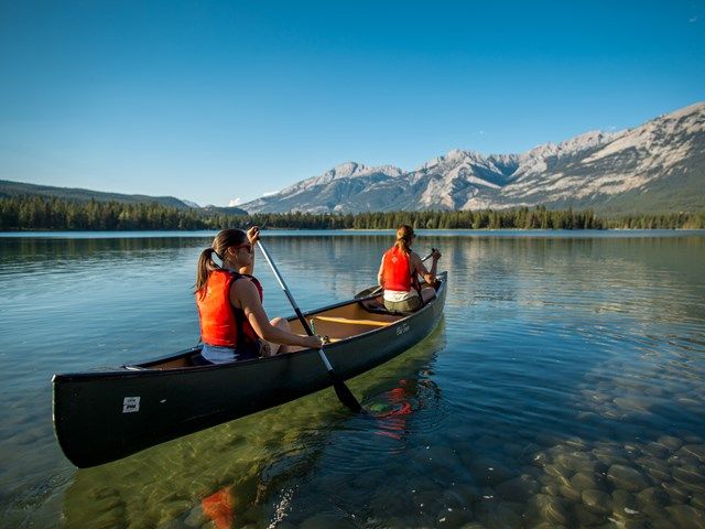 Couple canoeing on a lake in Jasper National Park.