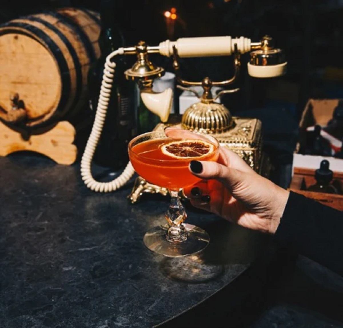 A lady holding a cocktail.