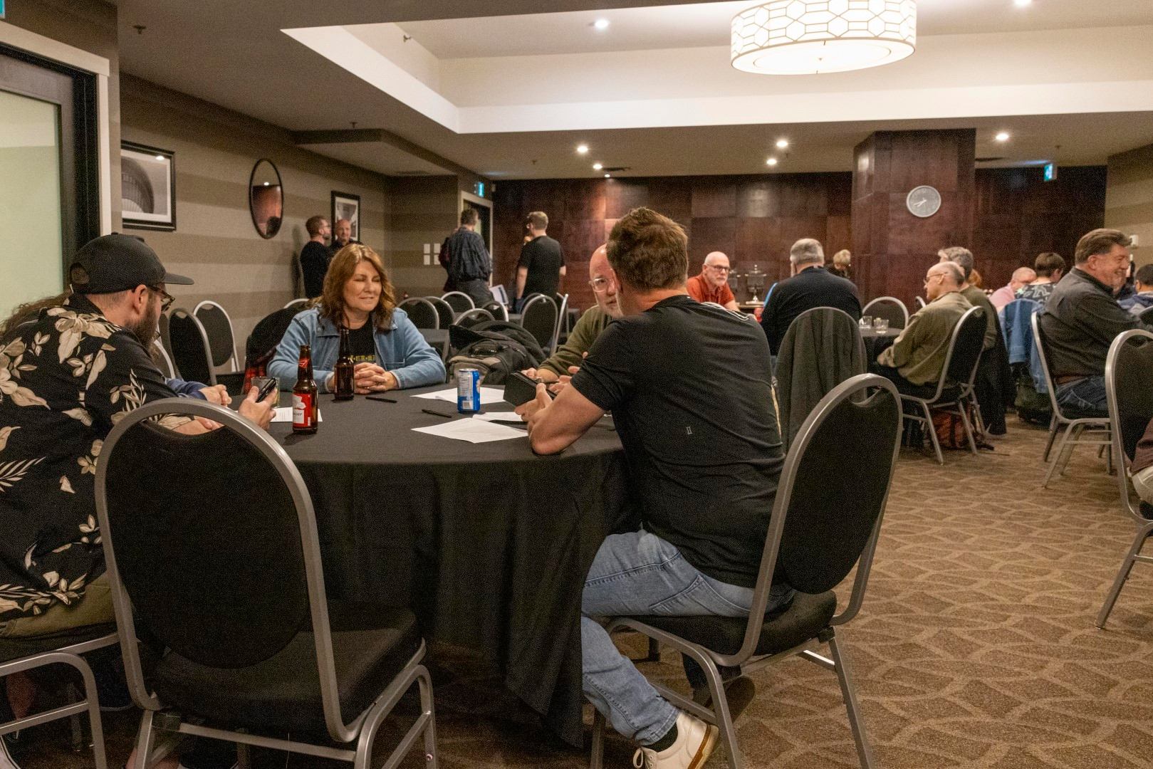 A group of people sat around round tables.