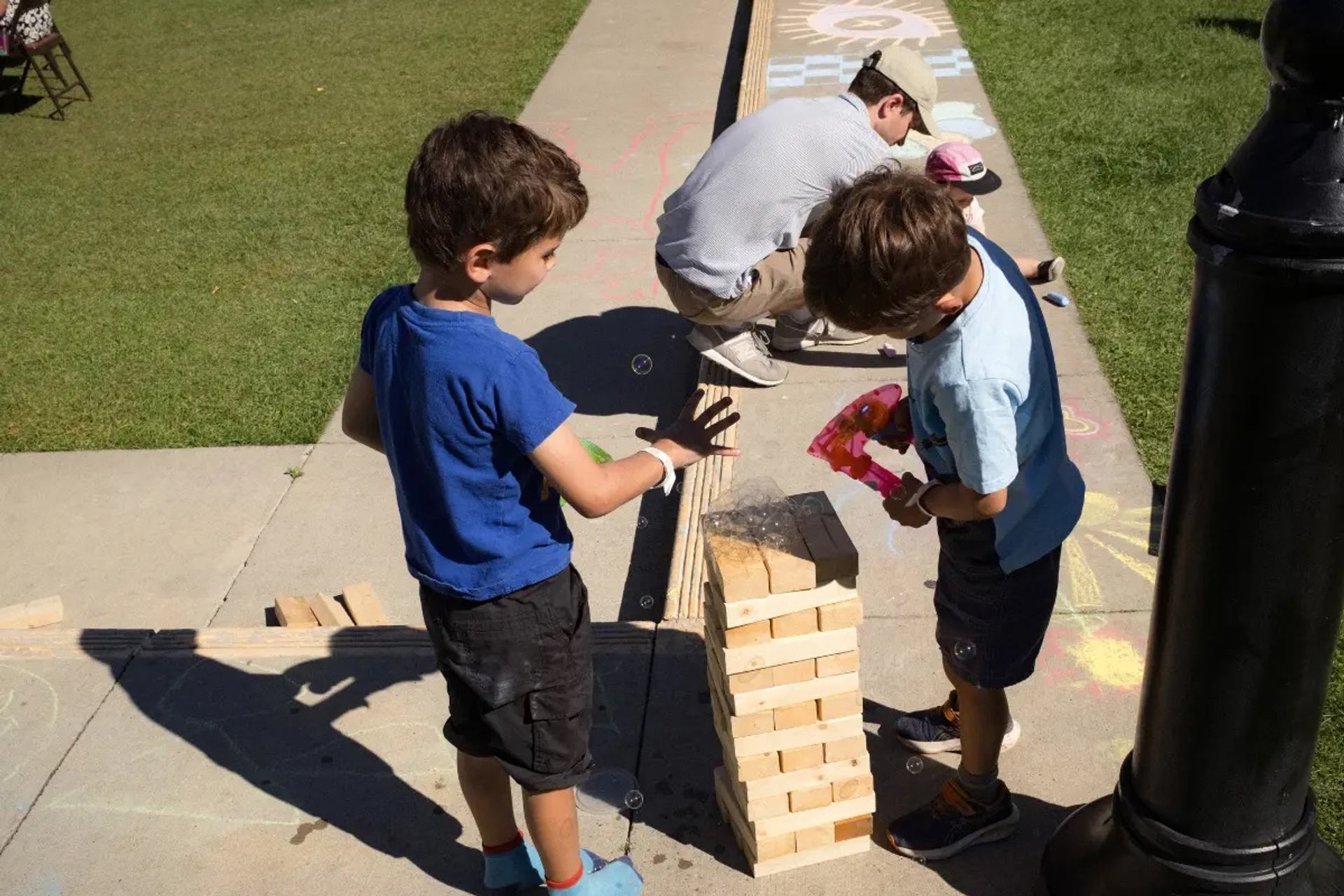 Two children playing with a tumble tower