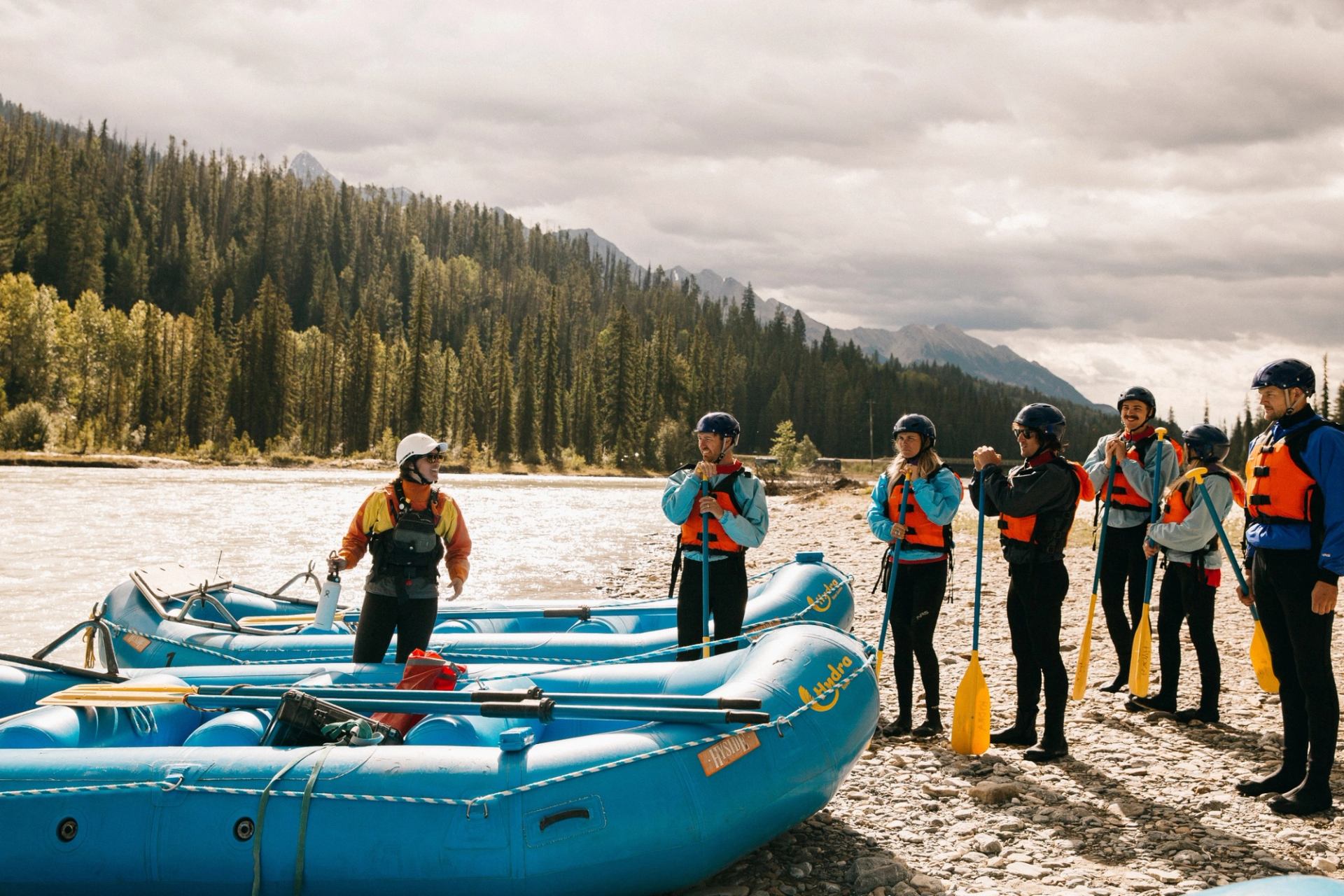 a group of people standing around two rafts