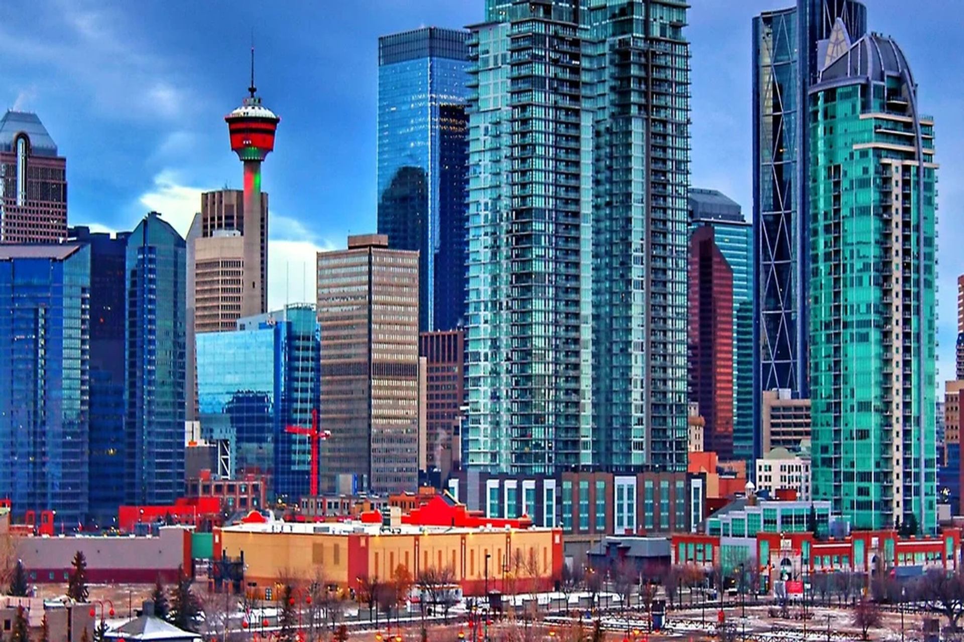 Calgary skyline with glass skyscrapers and the illuminated Calgary Tower.
