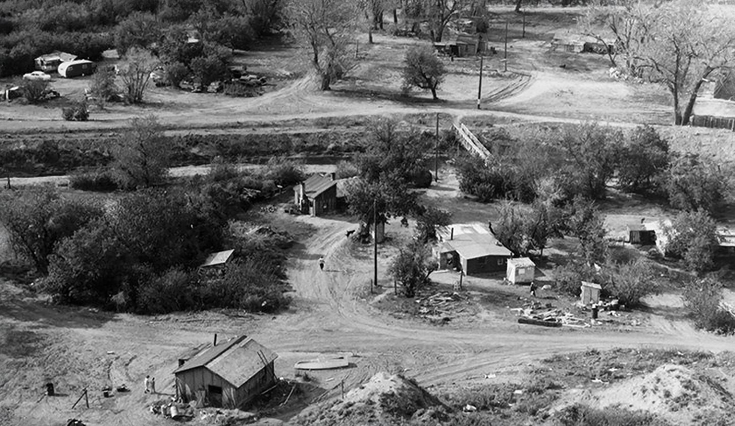 Aerial view of rural homes and dirt roads.