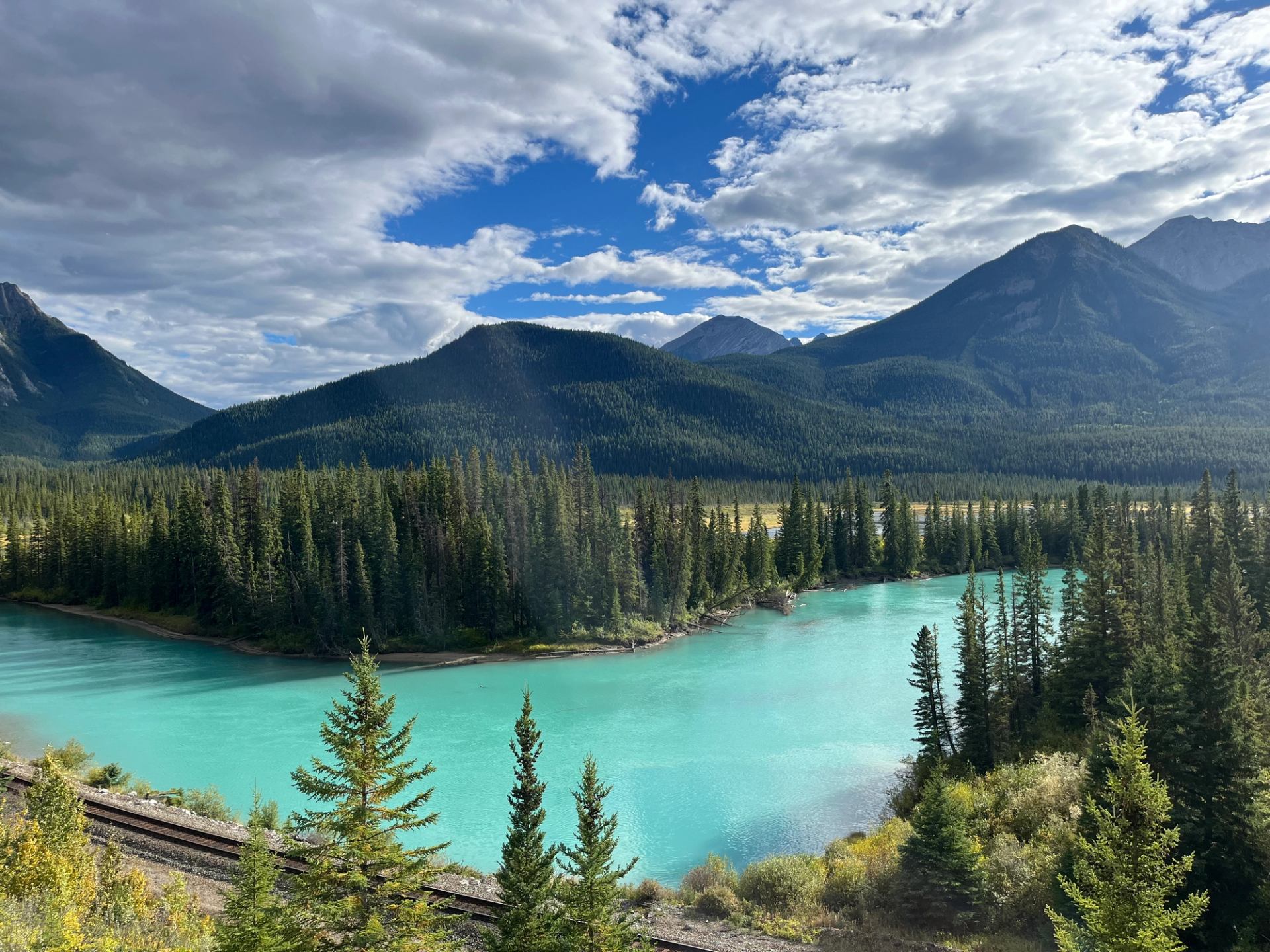 Turquoise river winding through a forested valley in the Canadian Rockies.