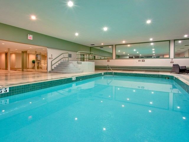 Indoor pool with bright lighting and modern design.