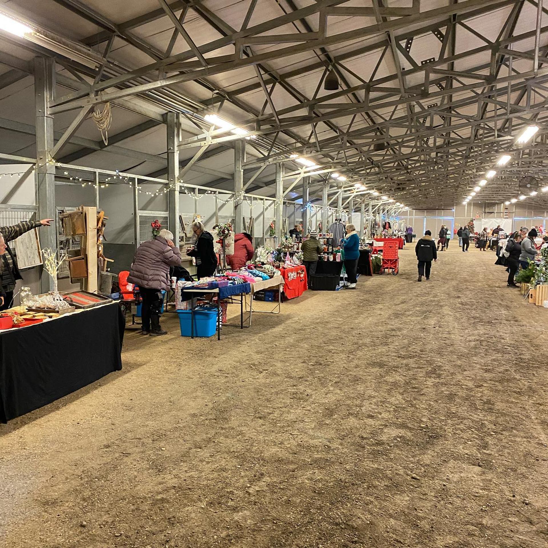 Shoppers walking past vendor stalls selling crafts and gifts
