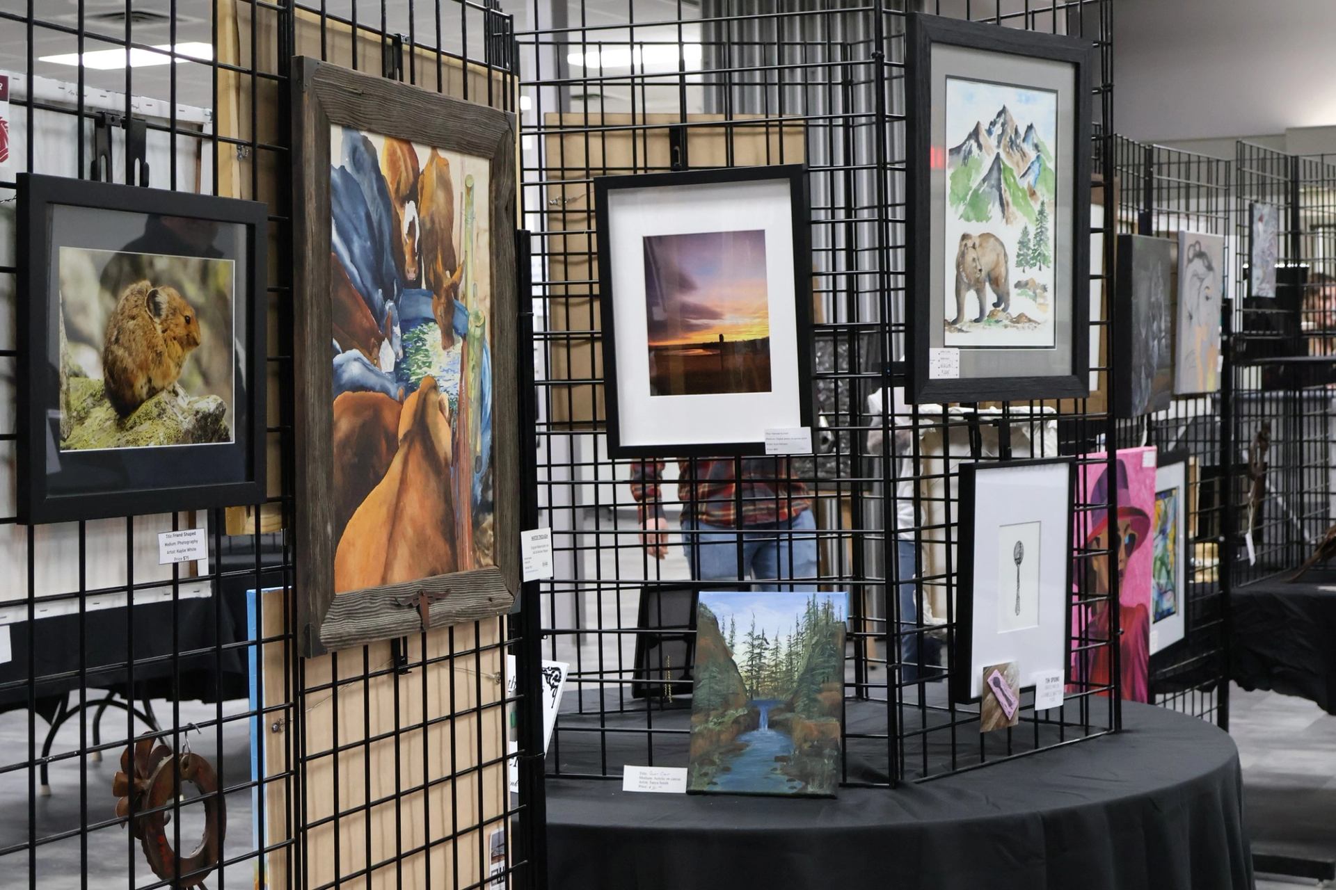 Art display with wildlife, landscape, and nature‑themed pieces at the Wainwright Arts Festival.