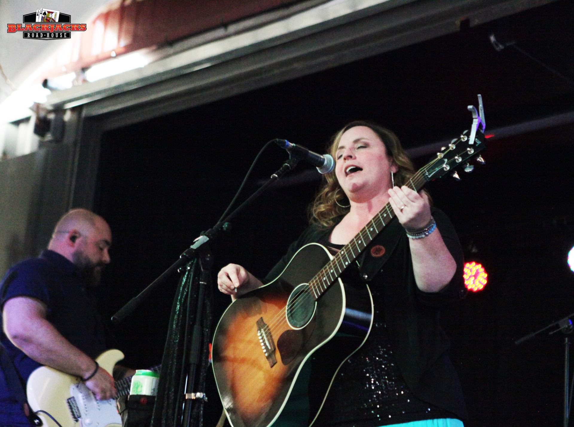 The Derina Harvey Band performing on stage