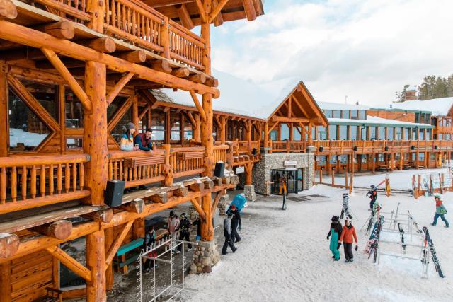 Skiers and snowboarders at the base of the day lodge, after a day of skiing at Lake Louise Ski Resort in Banff National Park