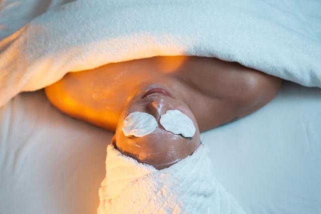 A woman relaxes on a massage table at Spa Jasper.