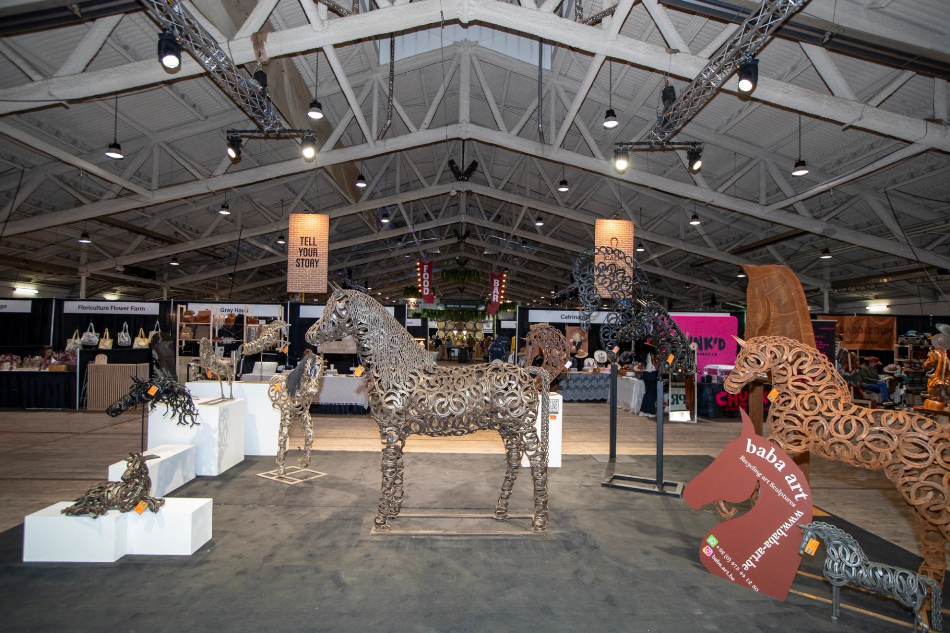 Metal horse sculptures displayed inside an exhibition hall at the Spruce Meadows ‘Masters’.