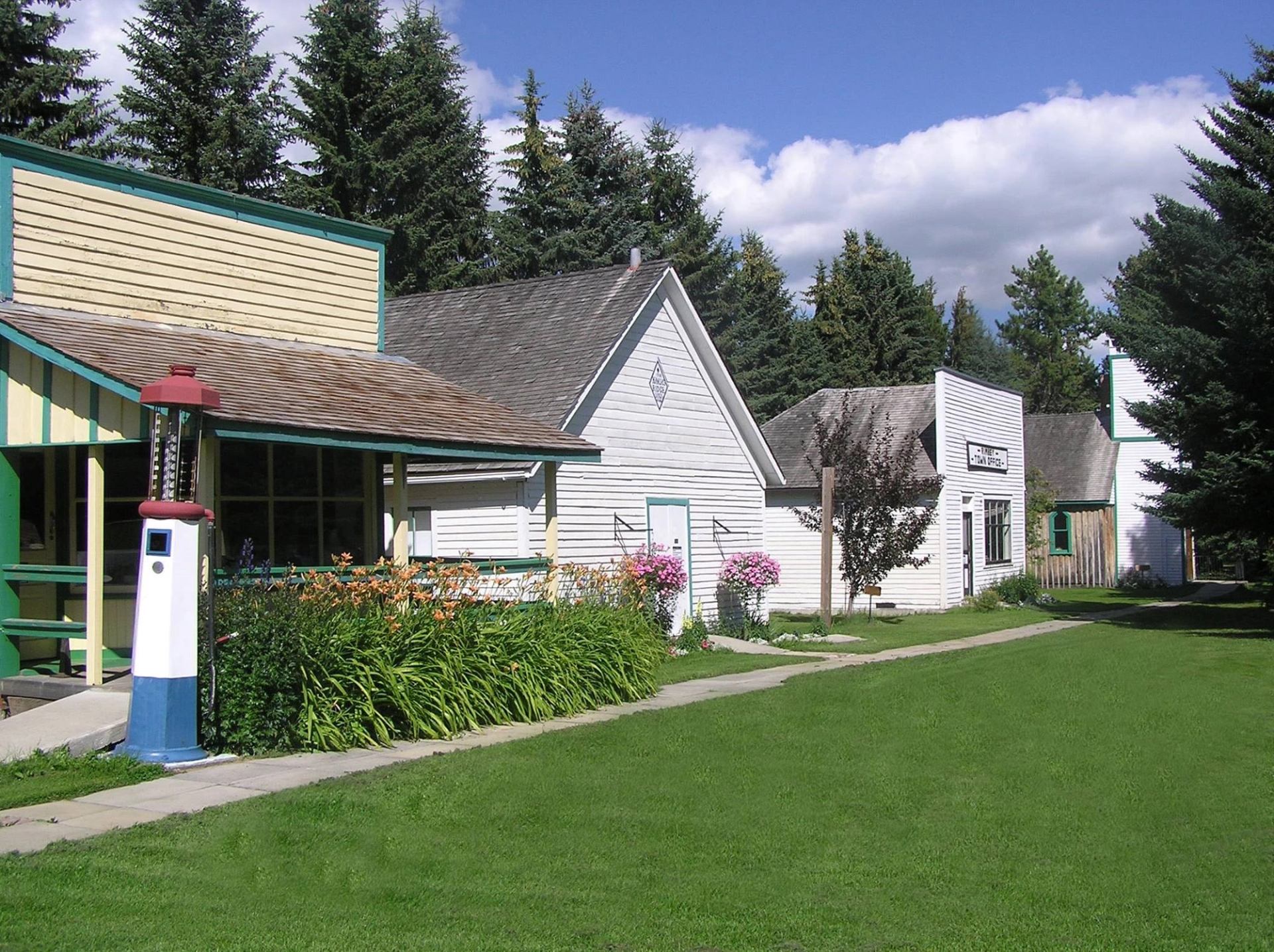 Old-style buildings line a path in a heritage village