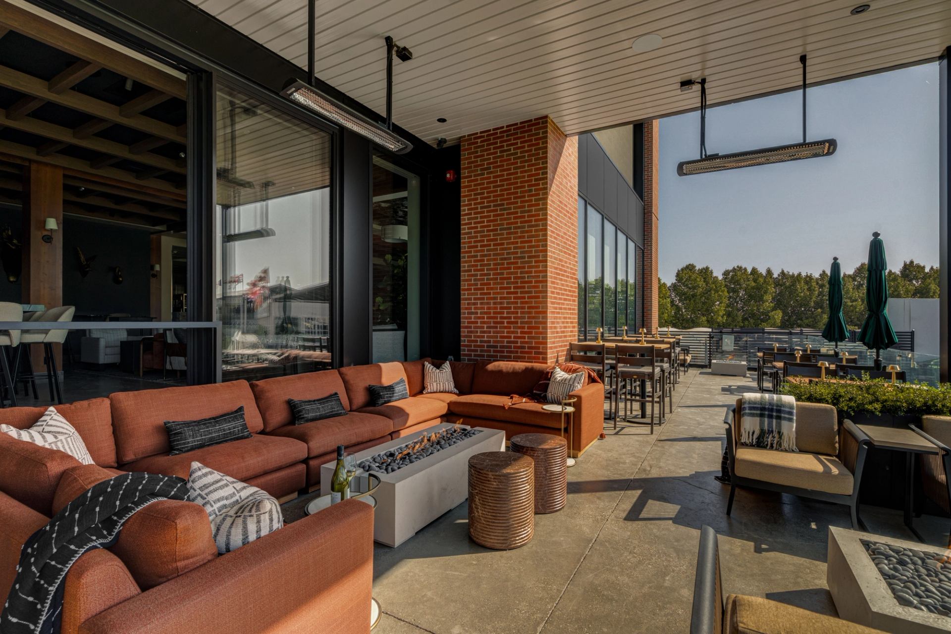Outdoor patio at Foxtrot at Spruce Meadows with lounge seating, fire table, and dining area.
