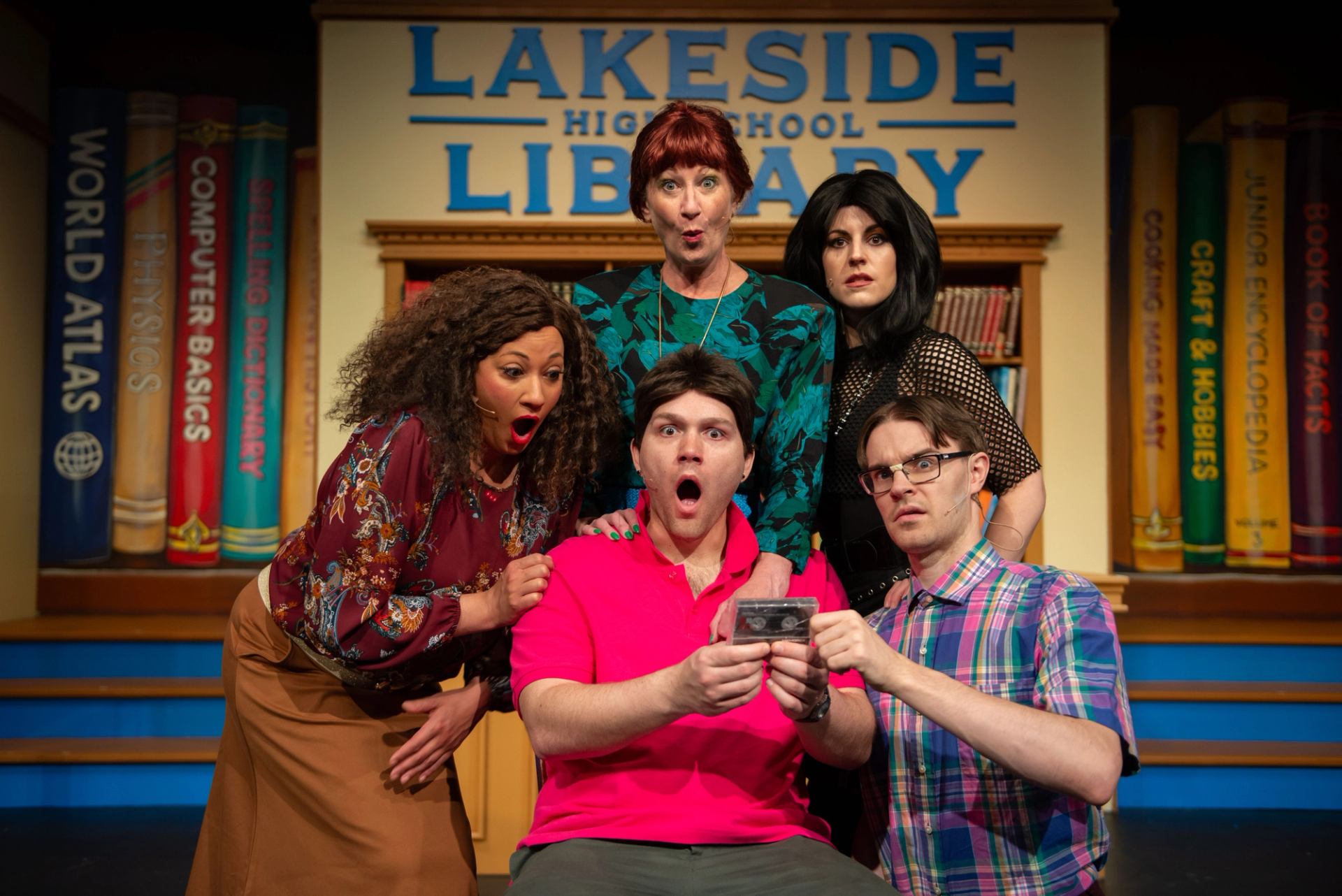 The 5-member cast of Back to the '80s: The Magic mixtape looking at a mixtape in shock