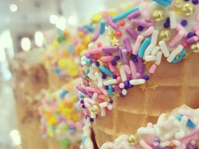 Waffle cones decorated with colorful sprinkles in a bright, close-up view