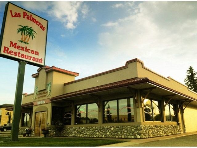 Exterior of Las Palmeras Mexican Restaurant with signage and stone trim.