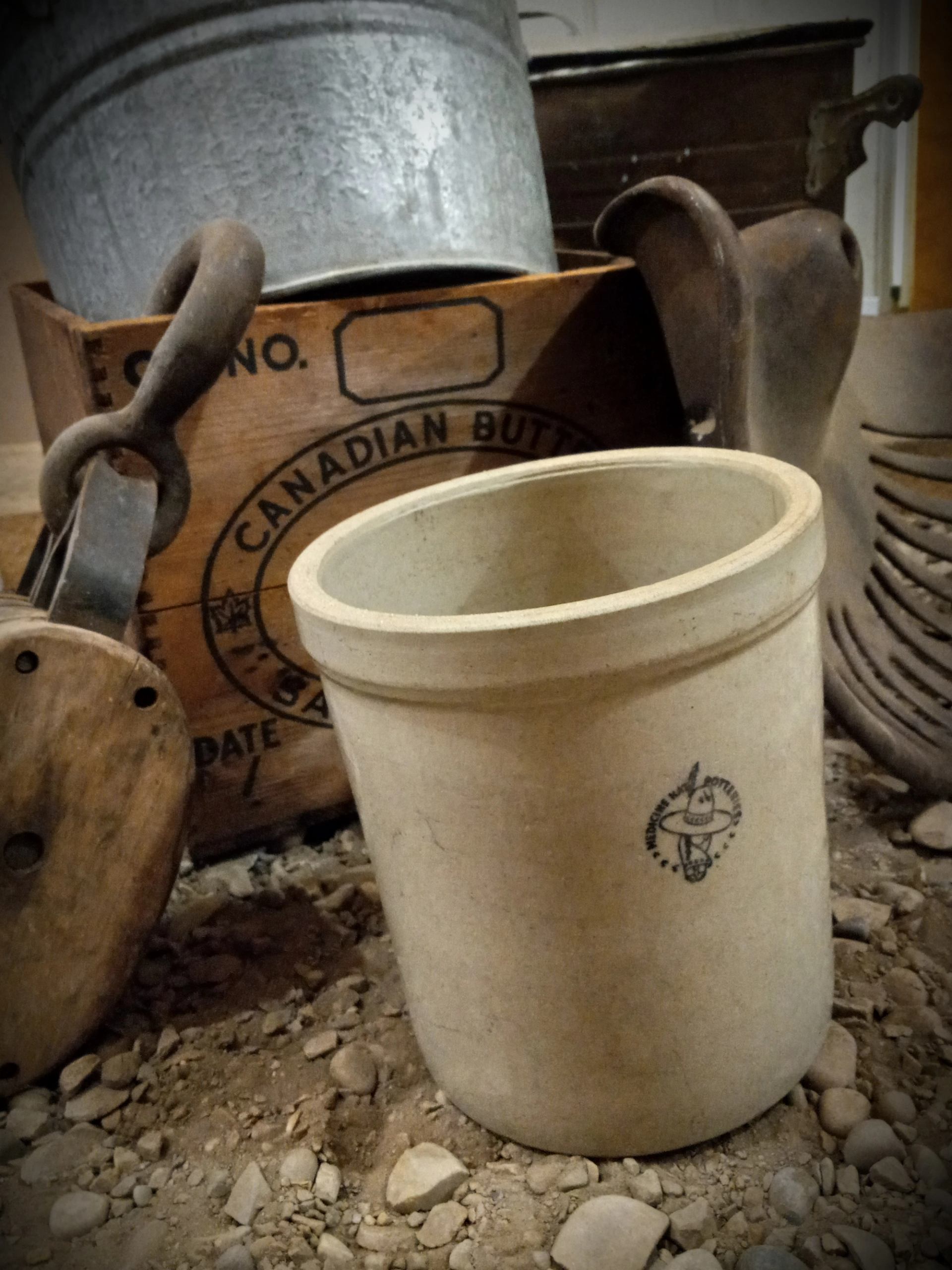 A crock, washtub, crate, tractor seat, and pully available for sale as products from heinventures.ca