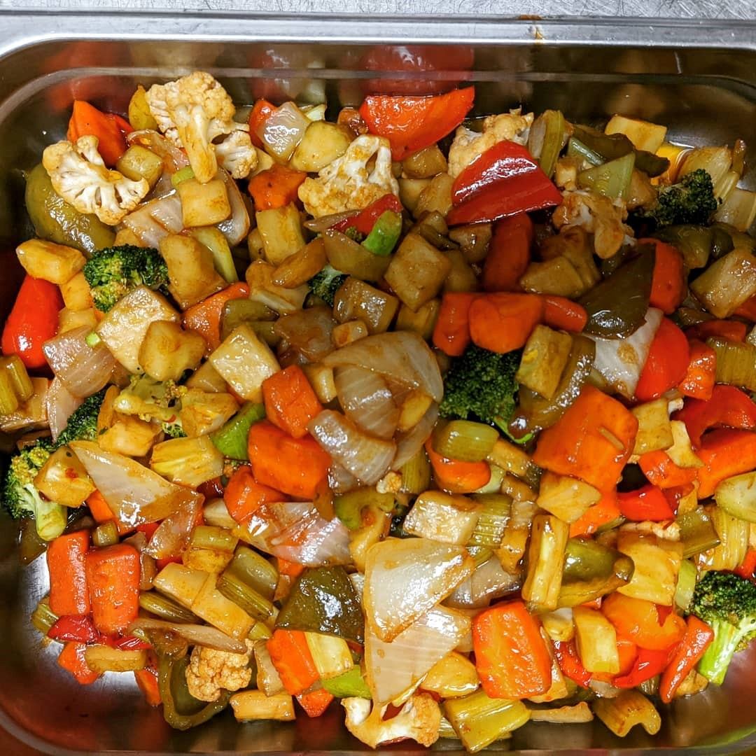 Stir-fried veggies with tofu at JB Grill & Bar, served fresh and colorful.