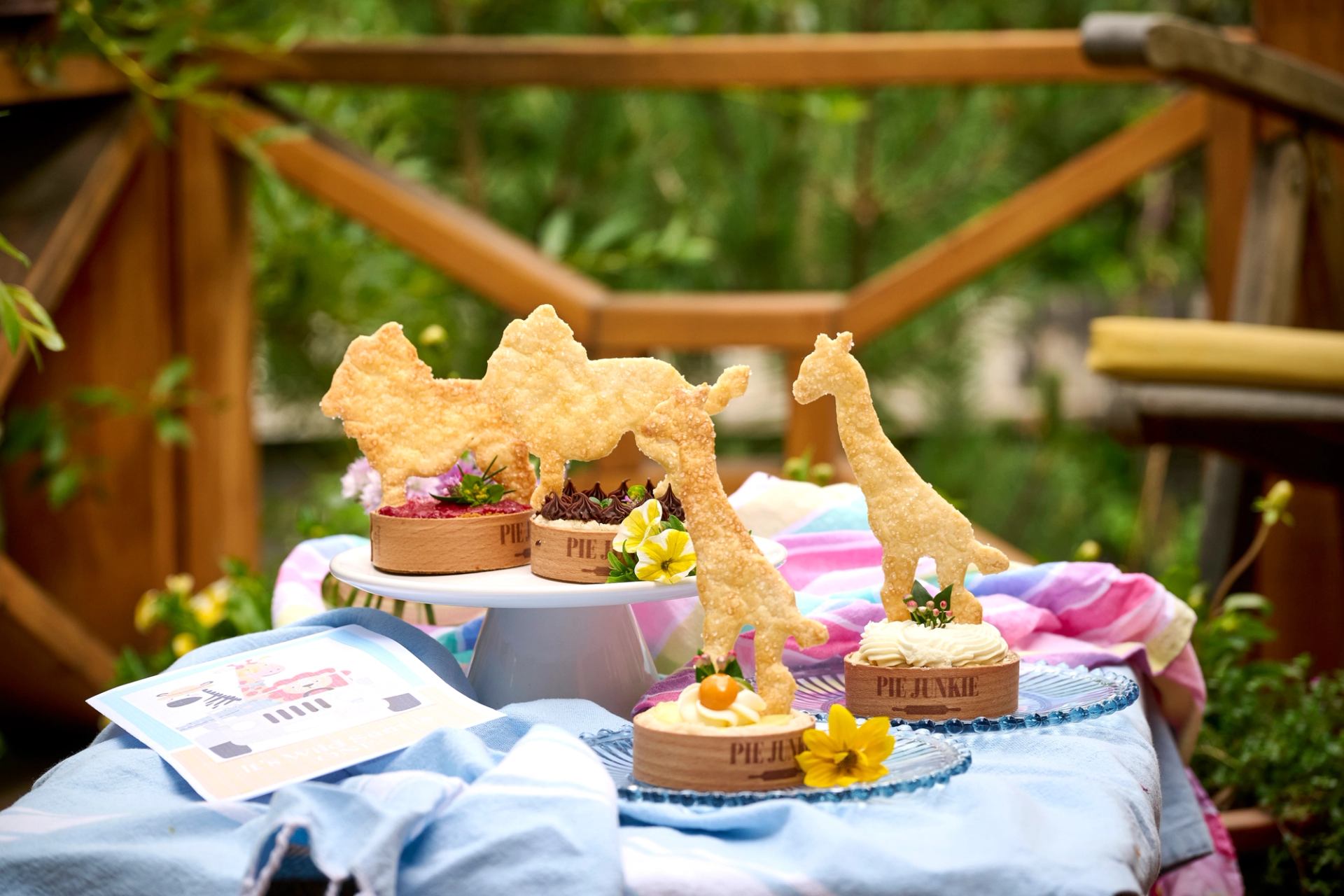Lions and giraffe shapes on top of Pie Junkie individual pies for a catered celebration.