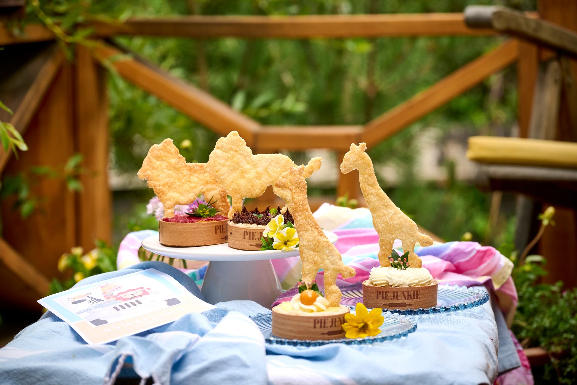 Lions and giraffe shapes on top of Pie Junkie individual pies for a catered celebration.
