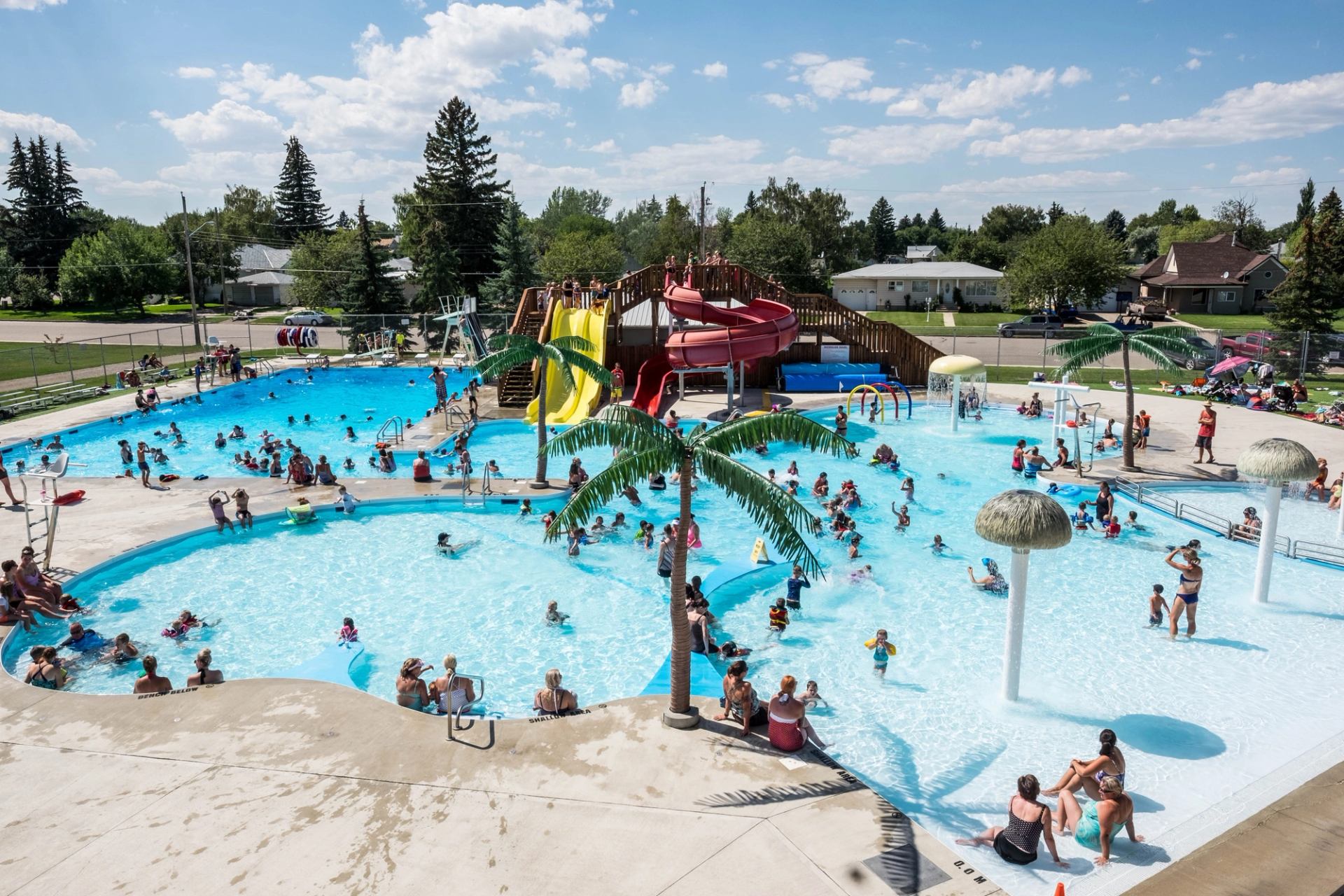 Water park with pools, slides, and palm trees at Centennial Park.
