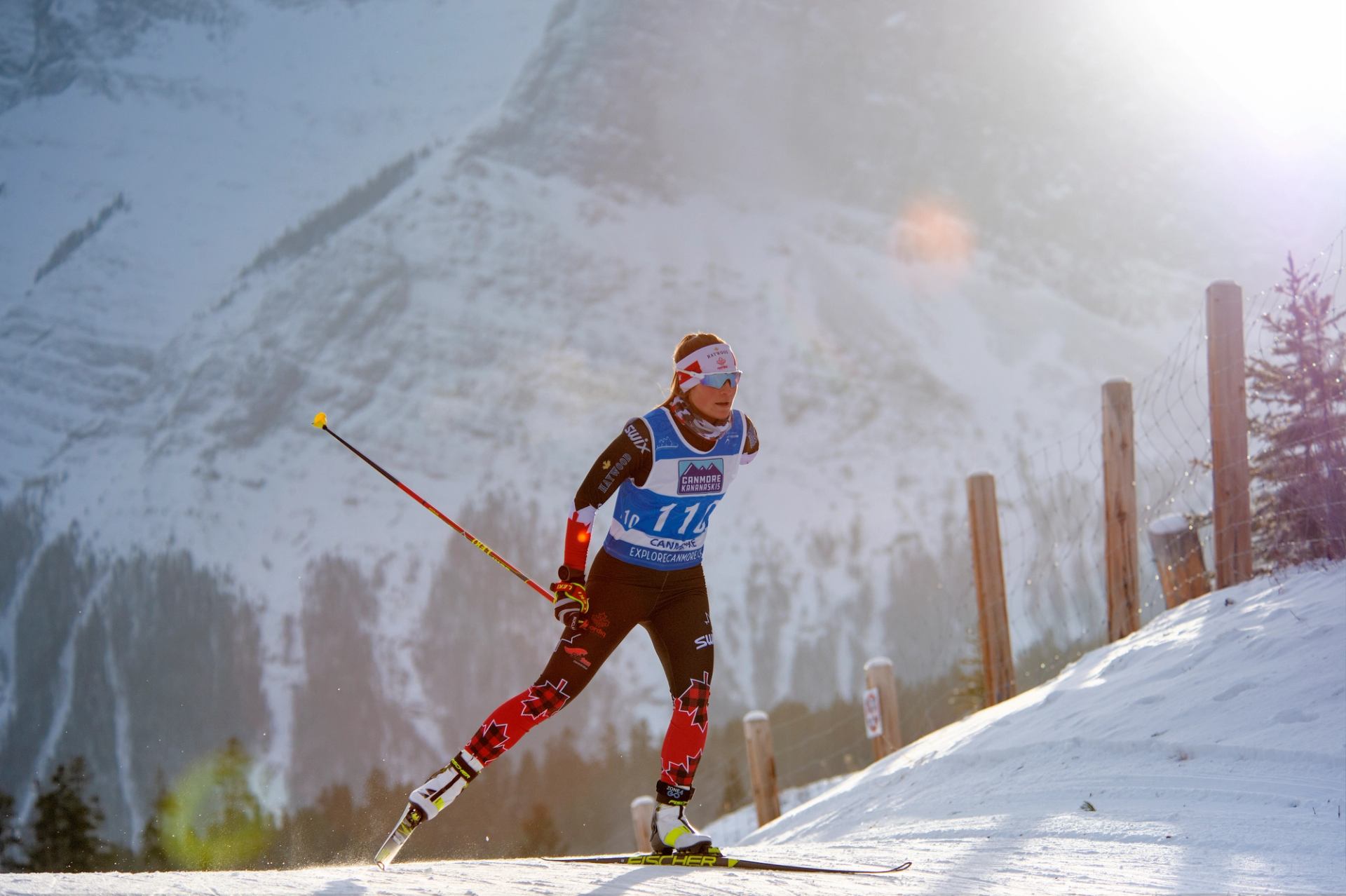 Para biathlete skiing during IBU World Cup on snowy mountain terrain.