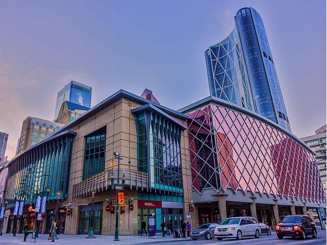 TELUS Convention Centre in downtown Calgary, featuring a skyscraper and shopping center.