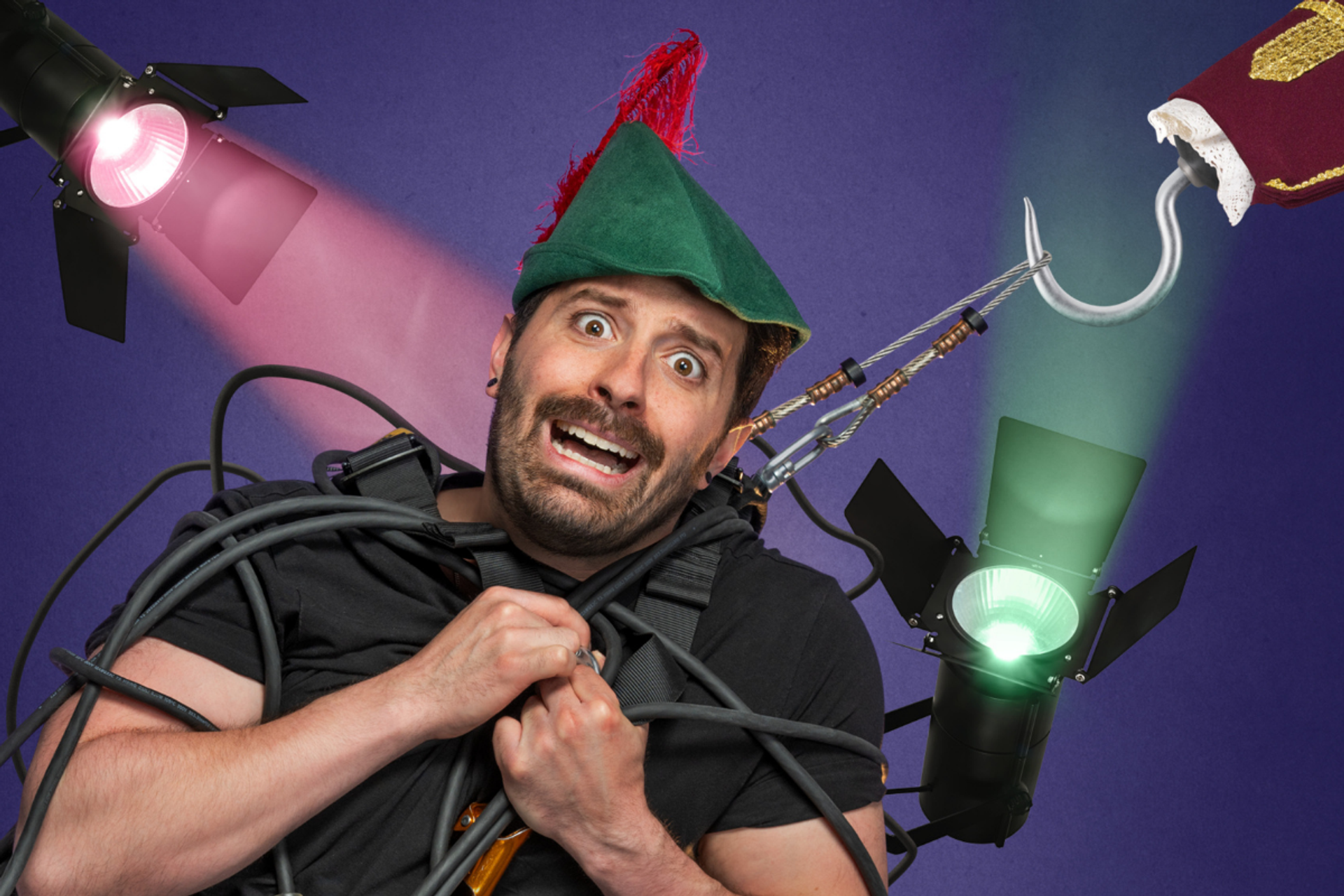 Person in green feathered hat tangled in stage cables under coloured theatre lights.
