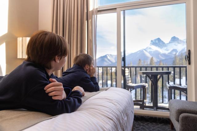 Kids enjoying the view from a room at the Malcom Hotel in Canmore.