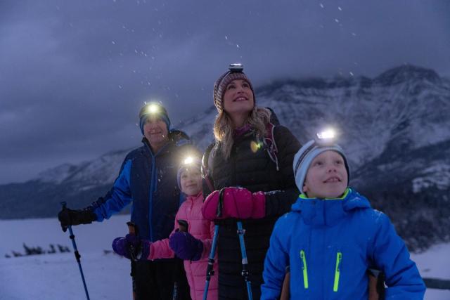 Family enjoying a guided snowshoe tour with Dark Sky Guides.