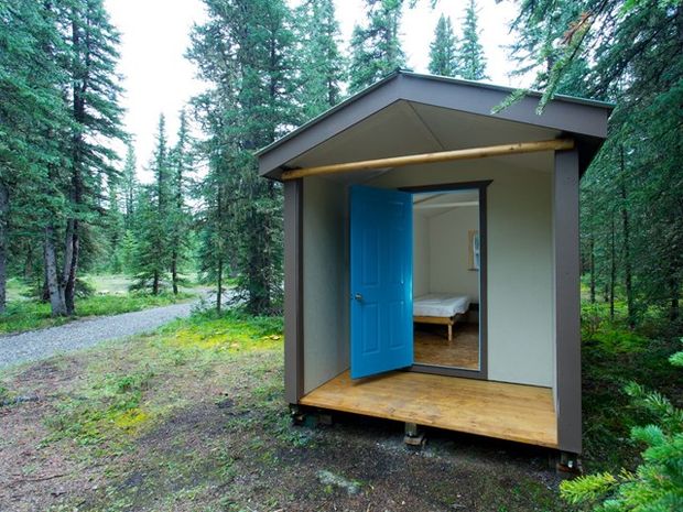 A close up of a Mukwah Cabin with the door open.