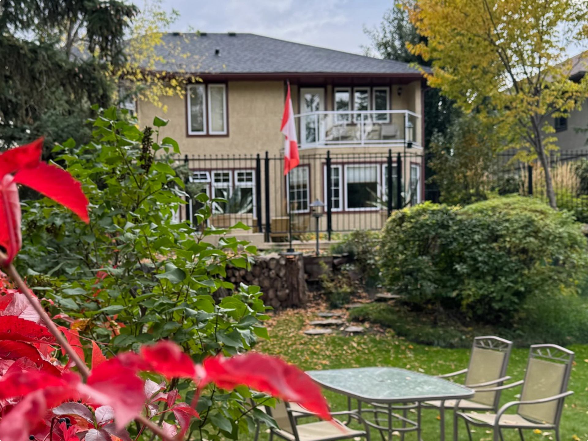 Exterior of the B & B with a patio table and chairs outside.